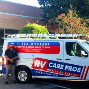 expert RV technician standing beside mobile repair van